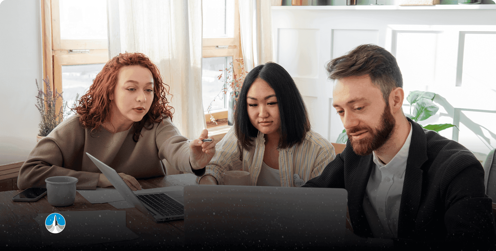 Three founders review their equity crowdfunding campaign details together on a laptop